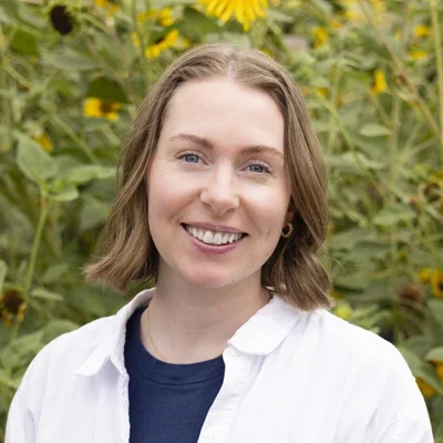 Chiropractic American Fork UT Liz Meet The Team New Platinum Chiropractic team member, Liz, smiling in sunflower field.